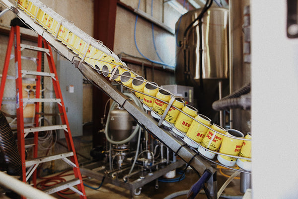 yellow and red canned beer