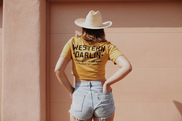 women in yellow tee and cowboy hat