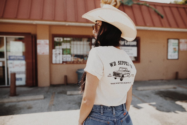 back of girl in cowboy hat