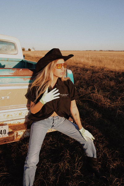 woman sitting on truck bumber