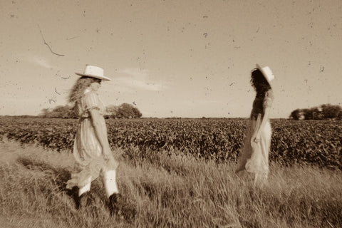 two girls standing in a field 