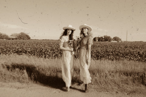 two girls standing in cornfield