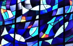 Christian fish symbols in blue and multicoloured stained glass window