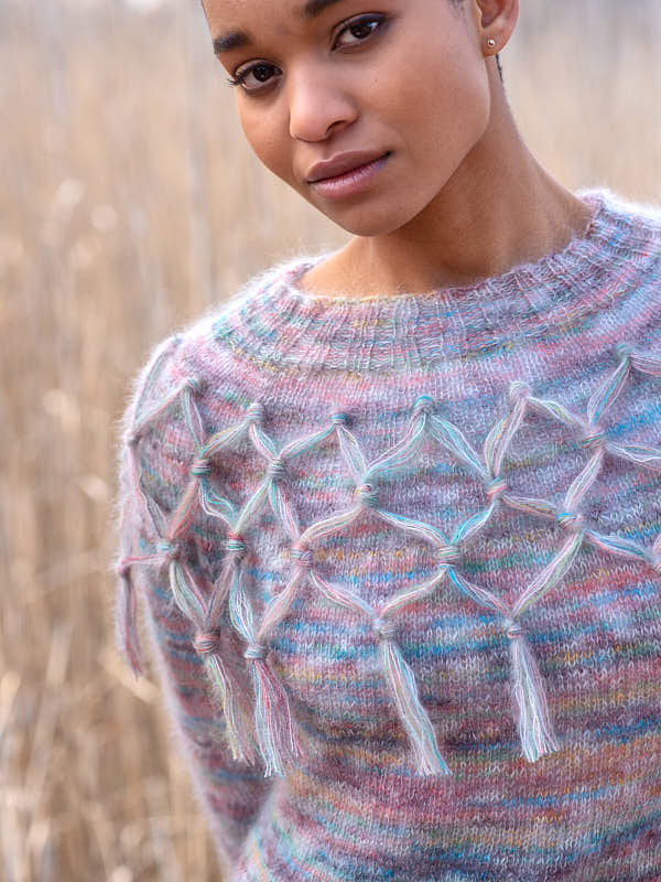 Dylla, a classic circular yoke pullover with added macrame motif flair. Worked using Aerial Color and Aerial held together. Shown knit in the colors #34103 Renoir and #3404 Driftwood.
