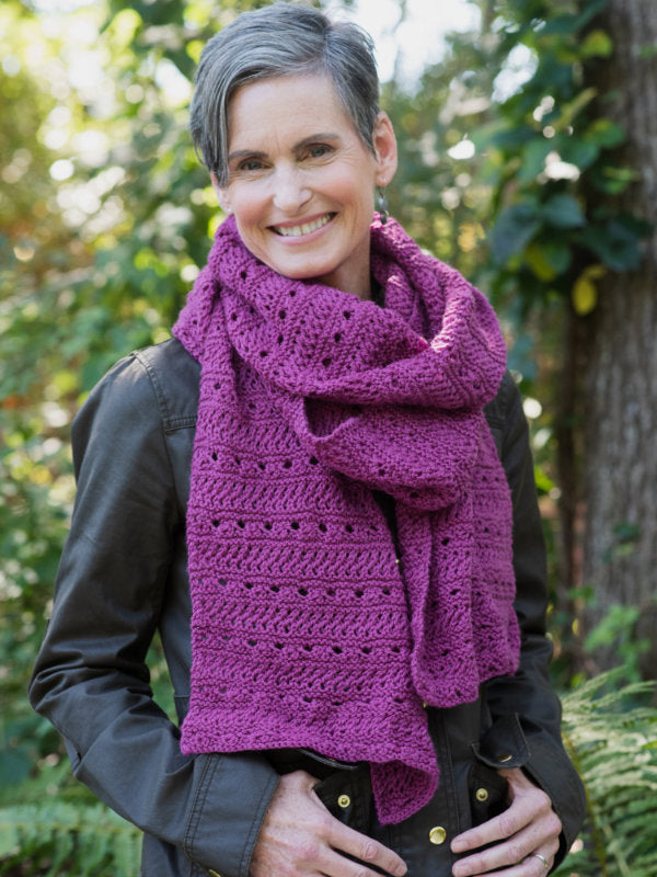 The Meander Scarf in a the color Magnolia 8337 on a smiling model