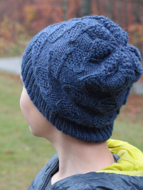 The Nye hat inspired by deoxyribonucleic acid knit in Ultra Wool Worsted color Denim 33154.