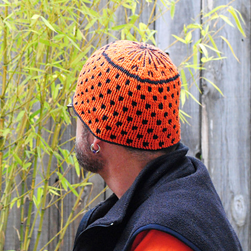 A Tempo Crochet Cap made with orange and black CoBaSi sock yarn.