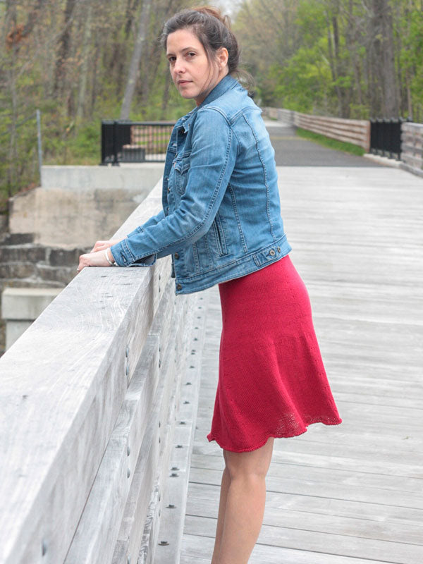 The Hibiscus knit summer skirt on a young lady standing on a bridge.