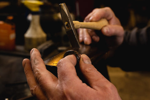 Master Craftsman, Scott Richter beating a copper ring in our studio