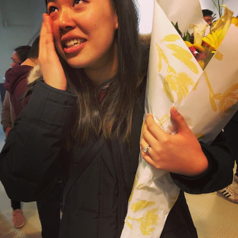 Woman crying with flowers after proposal