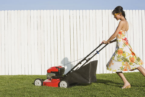 woman mowing lawn