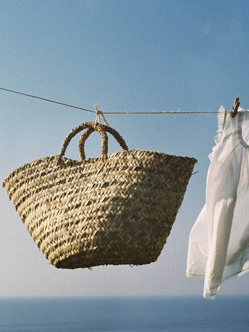 Bohemia Design Beldi Basket hung up on a washing line on a blue sky day