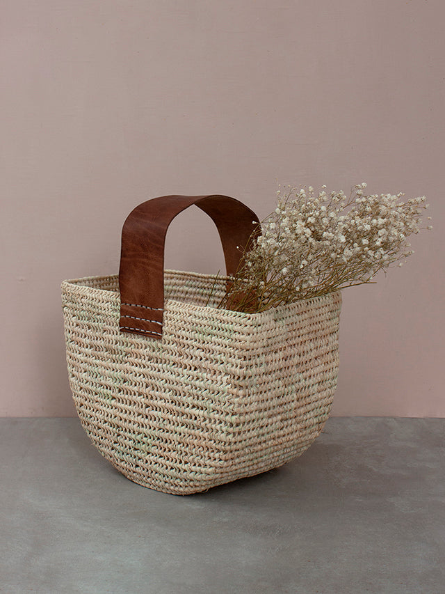 Forage basket with tan leather handle by Bohemia design filled with dried flowers