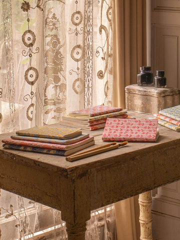 Block printed notebooks on a wood table