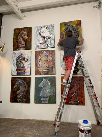 Gregory Installing Art on Wall of Gallery Haven NOLA