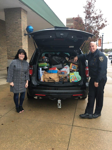 Linda with Chief Ron Moore from Wixom Police Department during "Stuff the Squad Car"