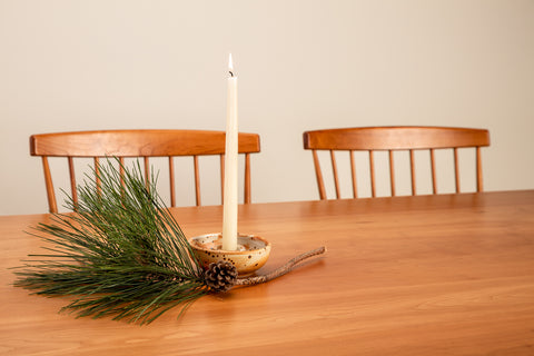 Shaker Dining Table with holiday table setting of candle and greens
