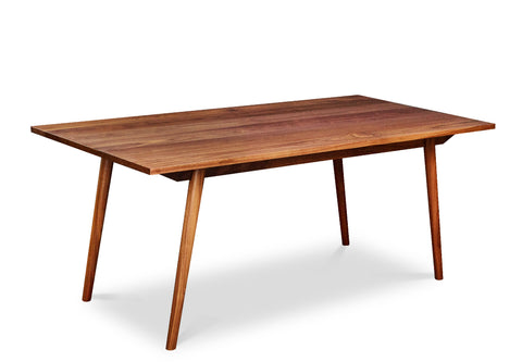Mid-century modern Fjord Dining Table with angled legs in walnut