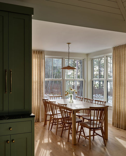 A kitchen redesign with green cabinets and hardwood chairs from local craftsmen