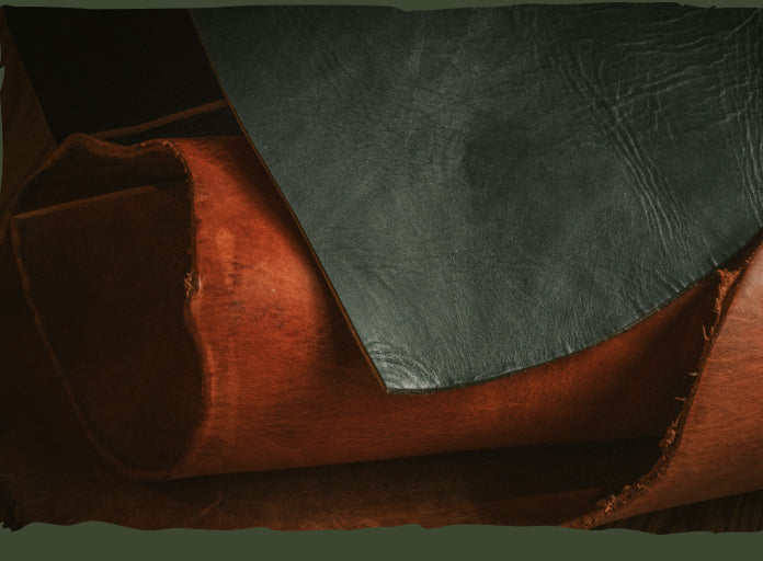 Close-up view of textured, rolled pieces of brown and dark leather.