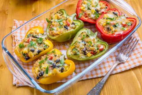 6 stuffed bell peppers sitting in a glass pan