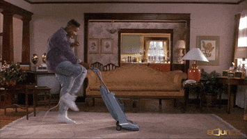 Man dancing with vacuum cleaner