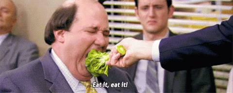man eating broccoli