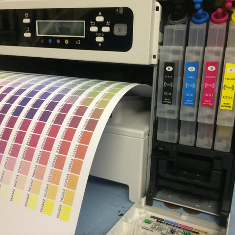 Colour test pattern and cartridge door open showing refillable ink cartridges.