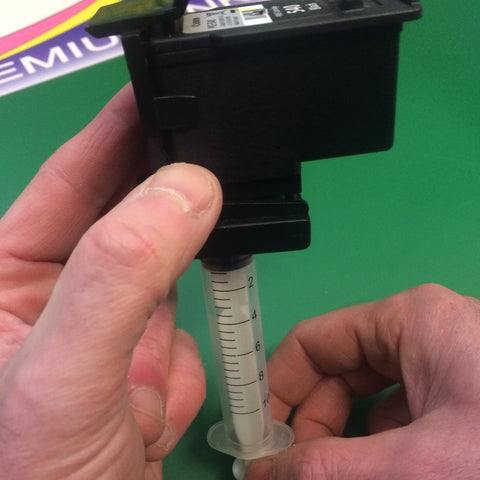 Suction tool being used to draw ink through the print head nozzles.