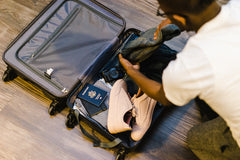 Man packing a suitcase for his travels