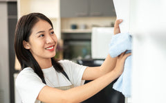 Woman Wiping Down Art on the Wall