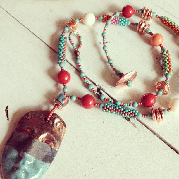 Red Cora, Ivory, and Coral Swarovski Pearls along with our Peyote Stitch beaded tubes make up this fun Necklace
