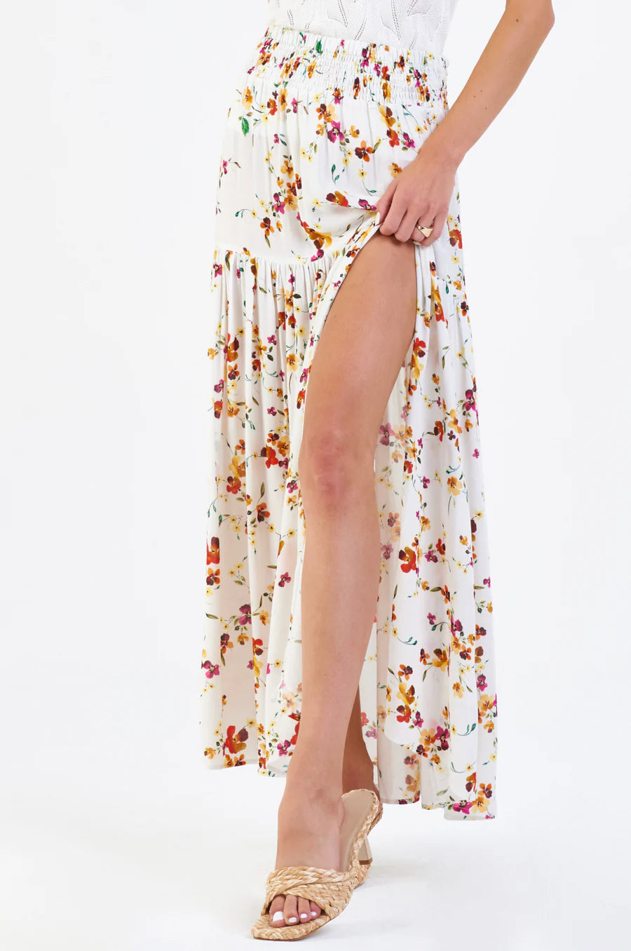 a model wearing a floral maxi skirt and sandals