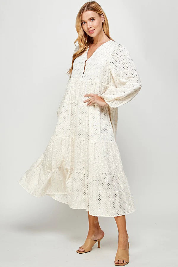 a model in a white eyelet lace midi dress