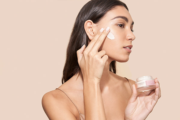 Woman applying Sagely Naturals Brightening CBD Night Cream.