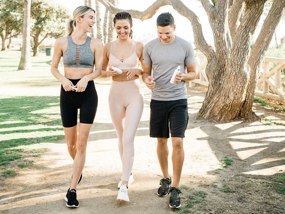 Three people carrying Sagely Naturals CBD Spray and Cream during workout
