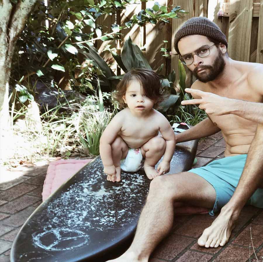 Sterling Spencer sitting outside with his son posing for the camera.