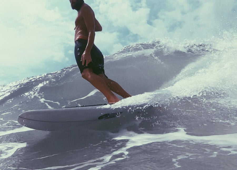 Sterling Spencer riding a wave on his surf board.