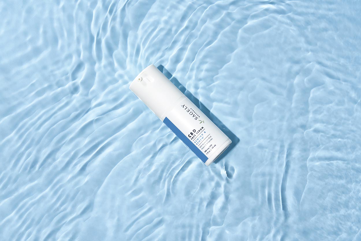 Sagely Natural's new CBD skincare face serum, pictured brightly on light blue water. 