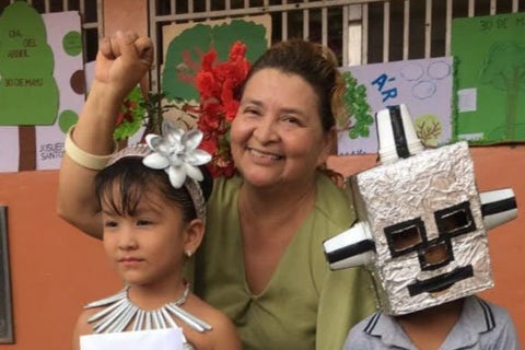 Teacher Deysi with two students wearing the creative costumes they created