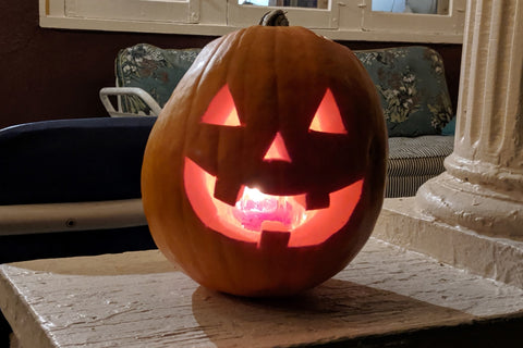 carved pumpkin smiling jack-o-lantern with candle inside