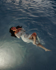 woman wearing dress and floating in water