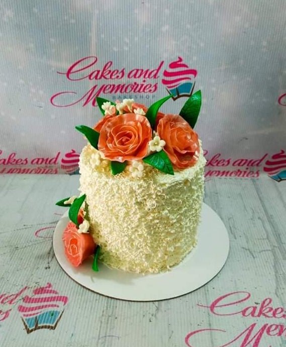 Beautiful one-tier 18th birthday cake with peach roses and white floral accents.
