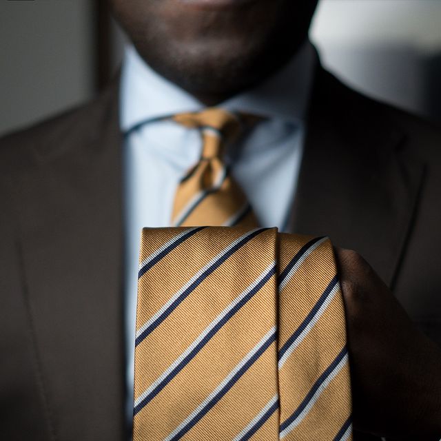 Aklasu Navy Blue and Grey Striped Mustard Yellow worn with a white shirt and brown suit.