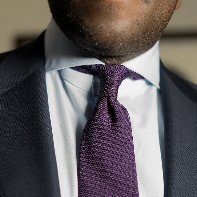 Aklasu Purple Grenadine Tie worn with a white shirt and dark bluesuit.
