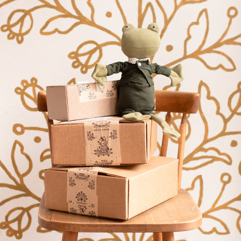 Lewis Toad atop a stack of Hazel Village packages