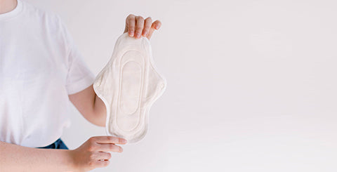  A woman holding open a reusable pad