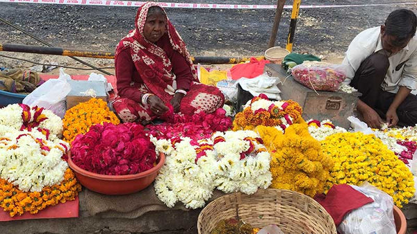 Indian woman selling flowers on the street.