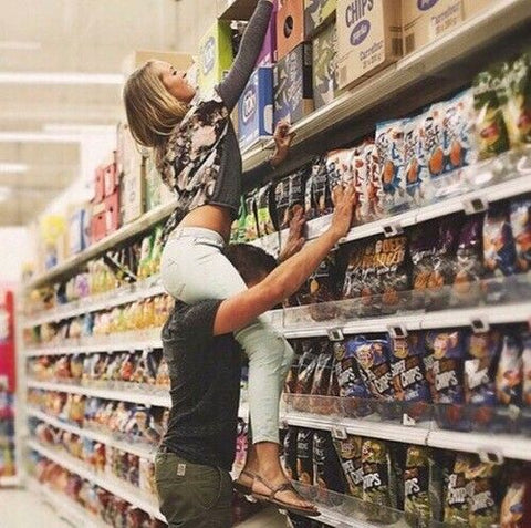Tall boyfriend and short girlfriend in grocery store 