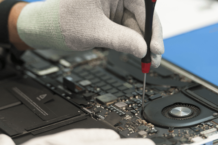 An electrical device being repaired with a screwdriver at our fleet street phone repair store